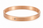 Rose gold bracelet with a diamond on a white background